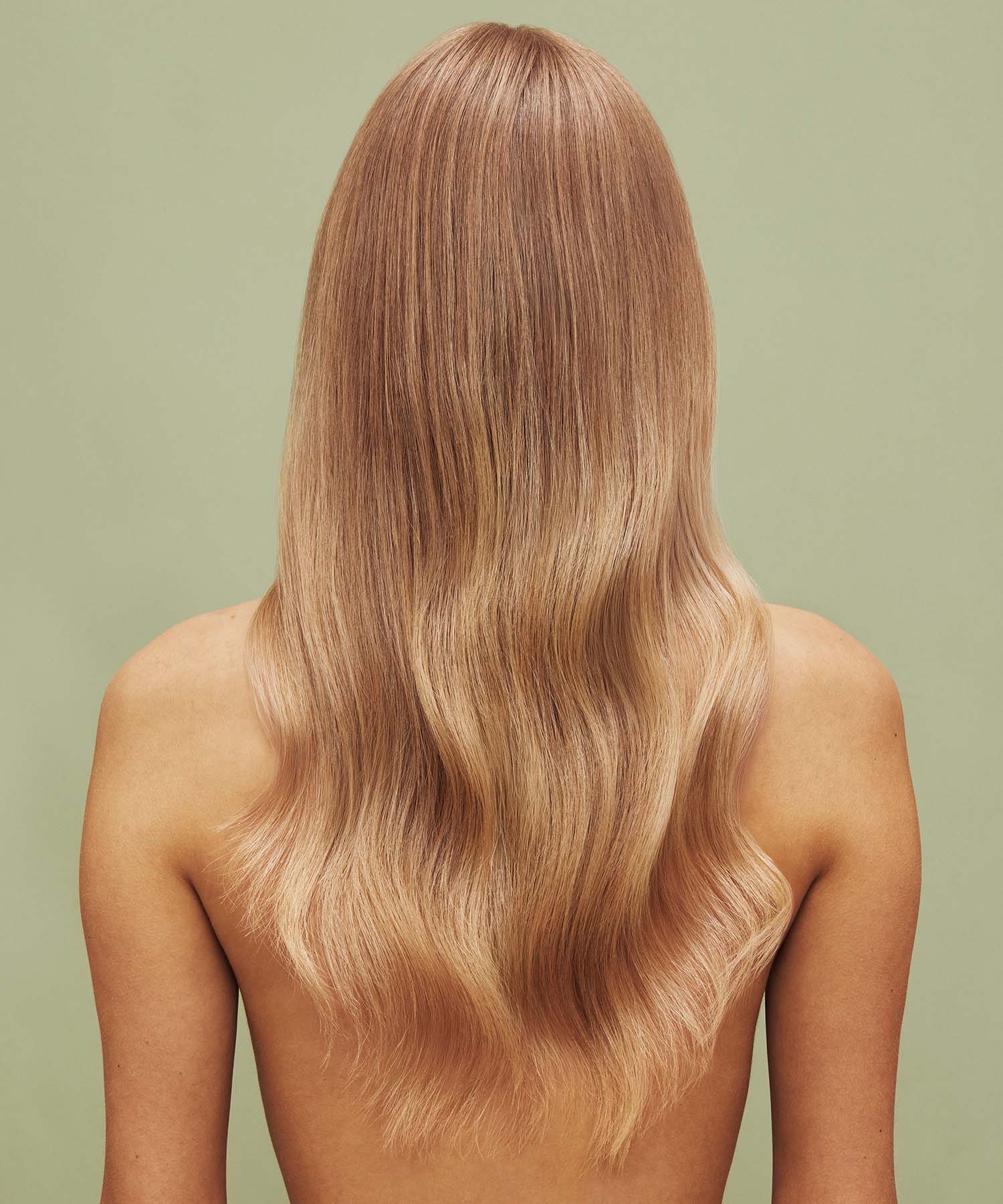 Result on hair after using Color Refresh Beige Blonde against a green background