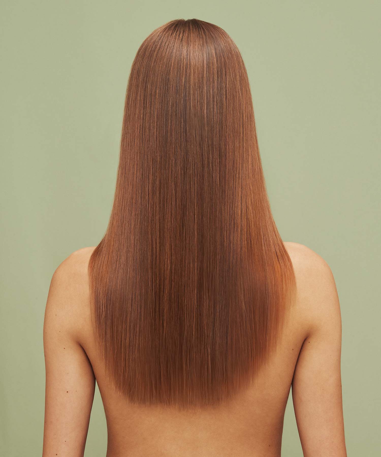 Result on hair after using Color Refresh Pink Peach against a green background